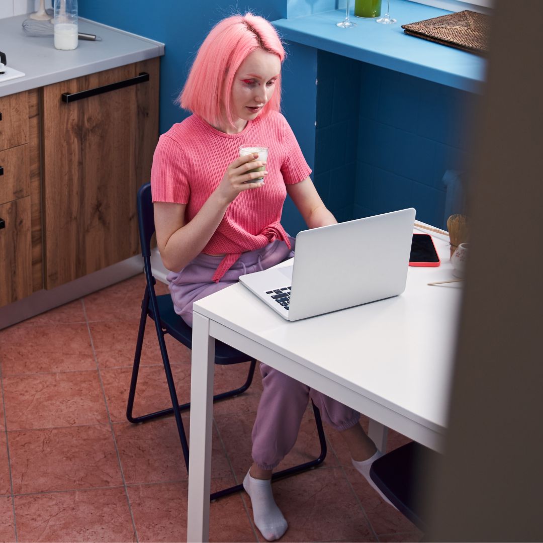 woman at table on her laptop
