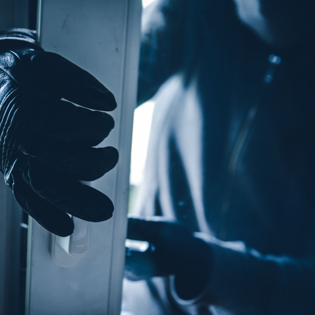 thief breaking into house with gloves on