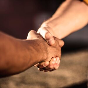 Two people shake hands