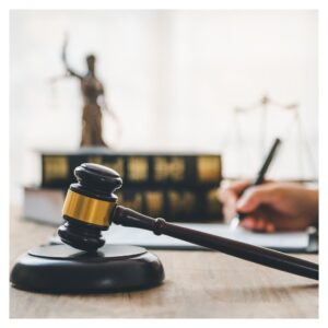 a gavel with law books in the background