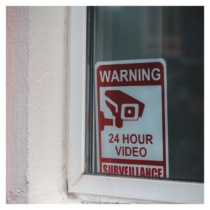 a sign warning of 24 hour video surveillance